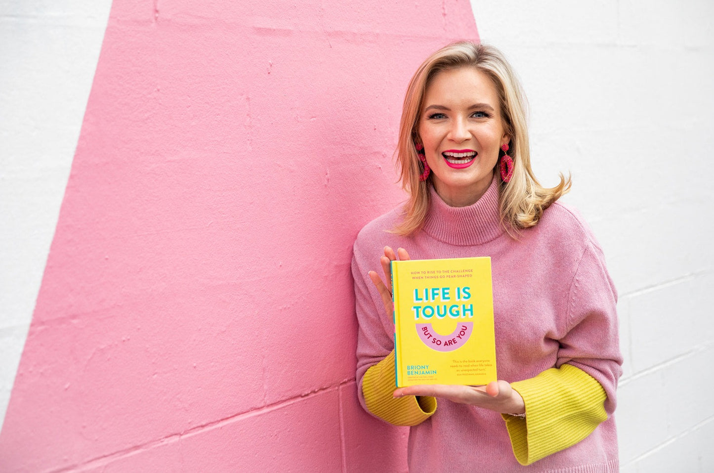 Briony Benjamin holding a copy of Life is Tough But So Are You